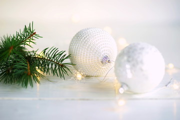 Christmas and New Year decoration. Christmas silber white balls on white background, soft focus. Merry christmas card. Winter holiday snowing xmas theme.