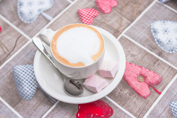 Cup of hot latte art coffee on wooden table.Cup of Cappuccino Coffee with Latte Art.copy space.Hot Cappuccino coffee with caramel .Coffee break.