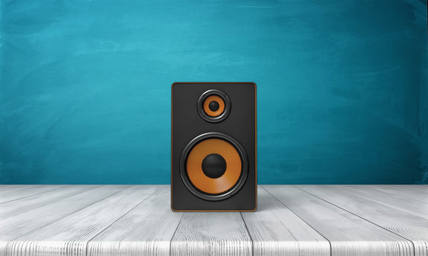 3d rendering of a one black speaker box with orange trim standing on a wooden table in front of a blue background.