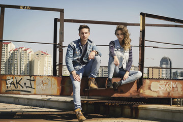 Young beautiful fashion couple wearing jeans clothes in daylight. Love concept.