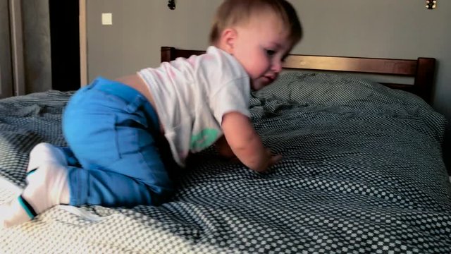 the baby boy climbs out of bed and runs
