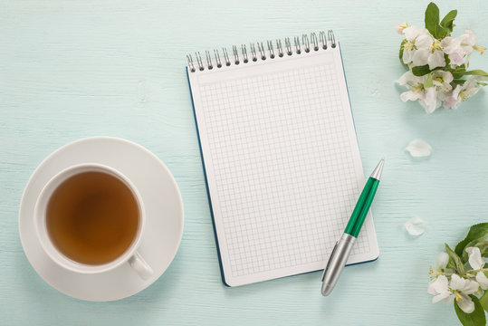  Notepad, pen, flowers and cup of tea