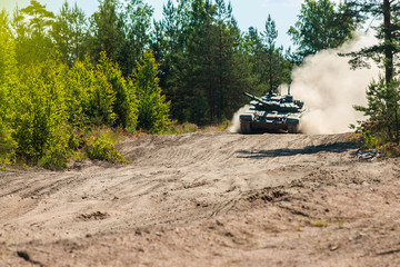 Fototapeta premium heavy battle tank attacks on the ground in the woods