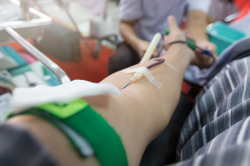 Nurse receiving blood from blood donor in hospital.