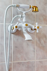 mixer white shower tile hanging on the wall in the bathroom