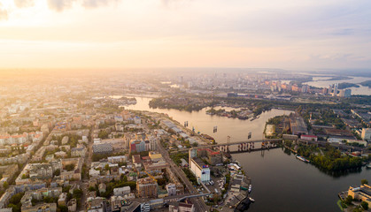 Panoramic aerial view of the old part of the city - Podol district. View of the Rybalsky Island at sunset.