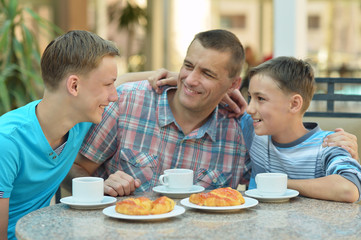 father and sons having breakfast