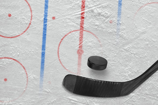A stick, a washer and a fragment of a hockey arena with markings