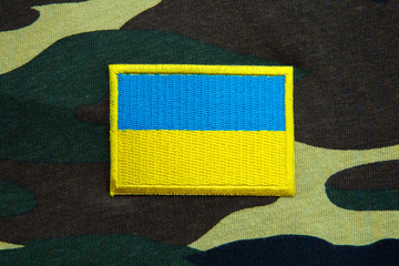 Army camouflage uniform with Ukraine yellow-blue flag 