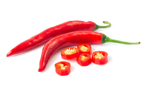 Closeup top view red chili pepper with sliced on white background, raw food ingredient concept