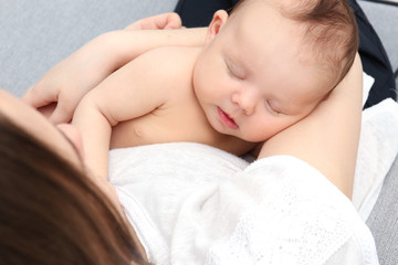 Fototapeta na wymiar Mother holding sleeping newborn, closeup