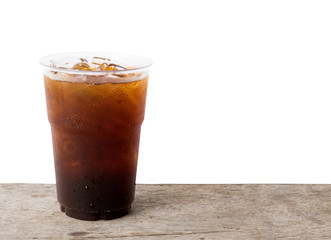 Close up ice of americano or black coffee on wood table with white background