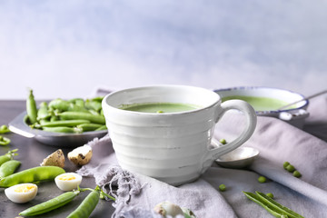 Puree from green peas in cup on table