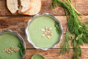 Delicious puree from green peas in bowls on wooden table
