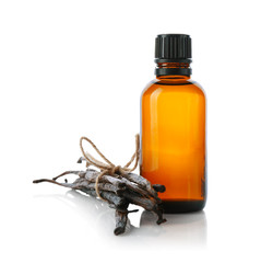 Bottle with vanilla extract and sticks on white background © Africa Studio