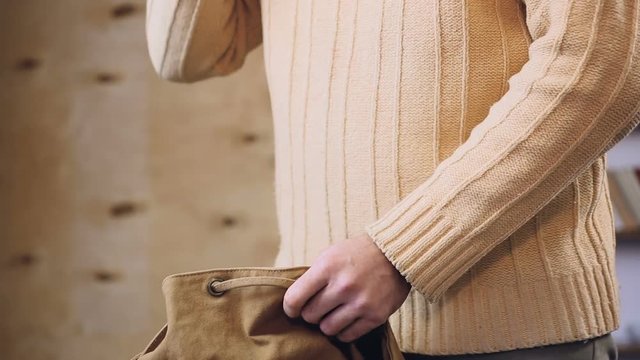 Man trying to find ringing mobile phone in backpack to answer call, tourism
