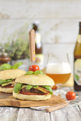 hamburger with beef katletoy and beer, decorated with basil and cherry tomatoes