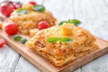 Tasty lasagna on wooden board