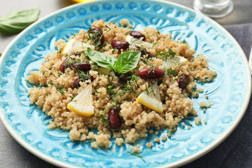 Salad with quinoa, basil and beans on plate, closeup