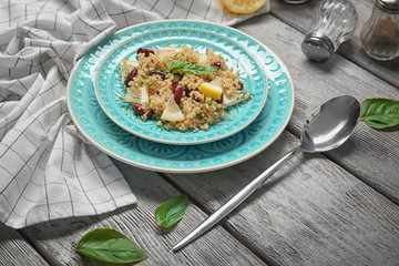 Salad with quinoa, basil and beans served on grey wooden background