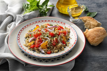 Salad with quinoa, tomatoes and onion served on plate