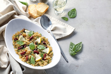 Salad with quinoa, basil and beans on grey background