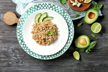 Salad with quinoa and fresh avocado on grey background