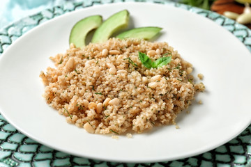 Salad with quinoa, beans and avocado on plate, closeup
