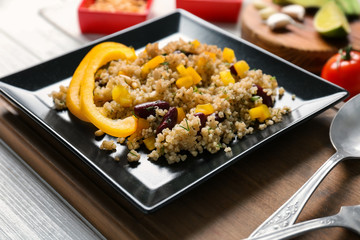 Salad with quinoa, pepper and beans on kitchen table