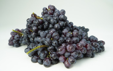 Fresh wet blue grapes isolated on white background