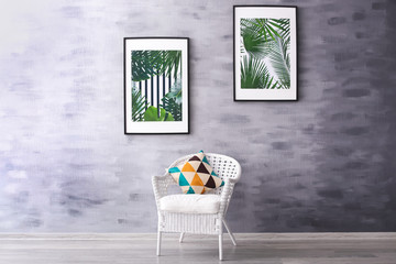 Pictures with tropical leaves in modern room interior