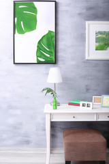 Modern room design with framed pictures of tropical leaves