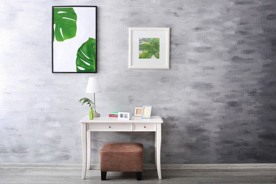 Modern room design with framed pictures of tropical leaves
