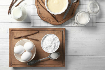 Composition with vanilla pudding and products on kitchen table