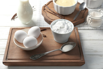 Composition with vanilla pudding and products on kitchen table