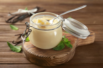 Vanilla pudding in glass jar on wooden table