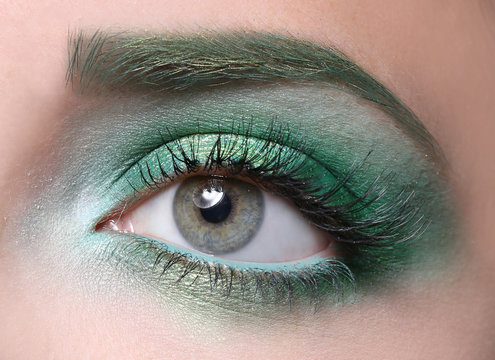Young woman with bright green makeup, closeup