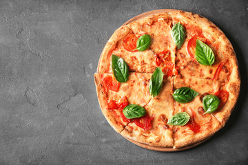 Delicious pizza with tomatoes and fresh basil on grey background