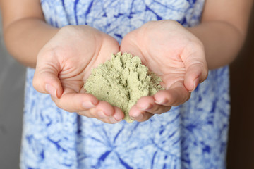 Woman with hemp protein powder indoors, closeup