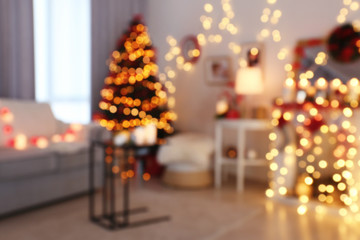 Room decorated for Christmas and beautiful fir tree, blurred view