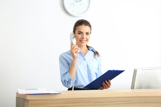 Young Female Receptionist Working In Office