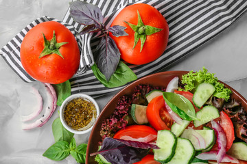 Delicious vegetable salad with cucumbers in bowl on table