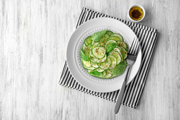 Cucumber salad in plate on table