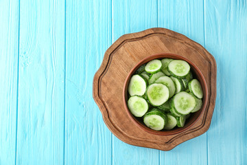 Slices of cucumber in bowl on table