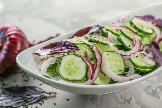 Fresh cucumber salad in plate on table, closeup