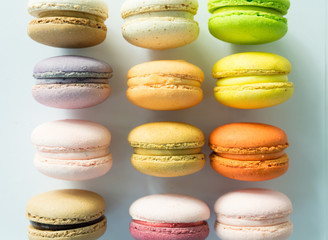 Colorful macarons line-up on white backgound, selective focus
