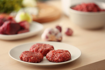 Plate with cutlets made from forcemeat on table