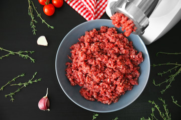 Meat grinder with fresh forcemeat on kitchen table