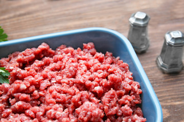 Baking dish with fresh forcemeat on table