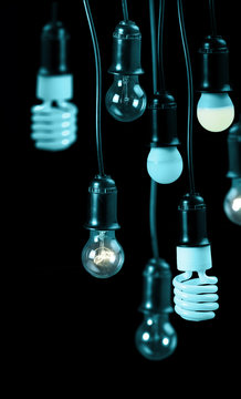 eight blue electric lamps in receptacle isolated on black